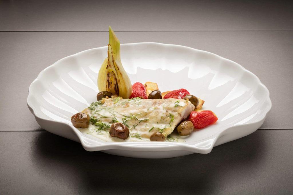 Baked sea bass with vermentino, olives and wild fennel